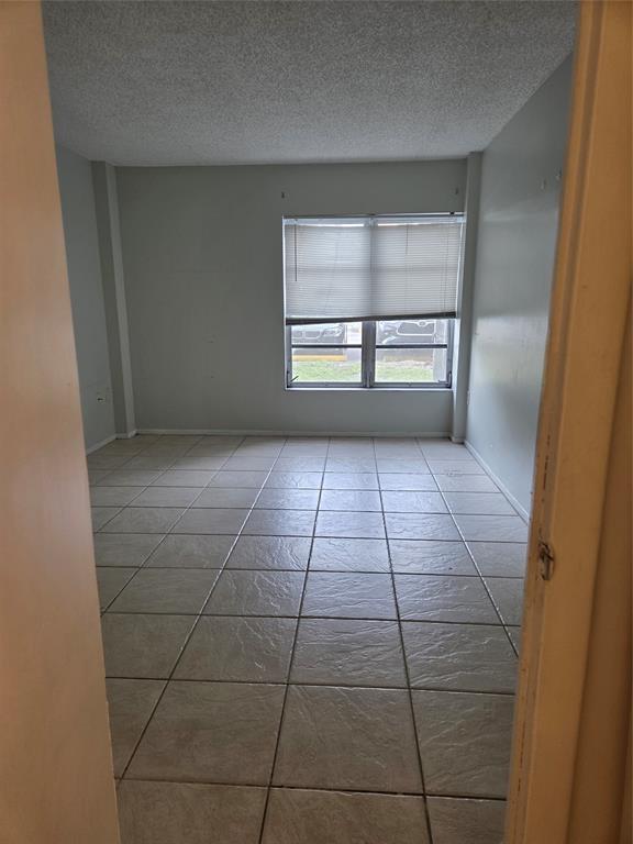 4158 Inverrary Drive, Unit 104 Lauderhill, FL 33319 - Photo 8 of 40 a view of a room with an empty space and window