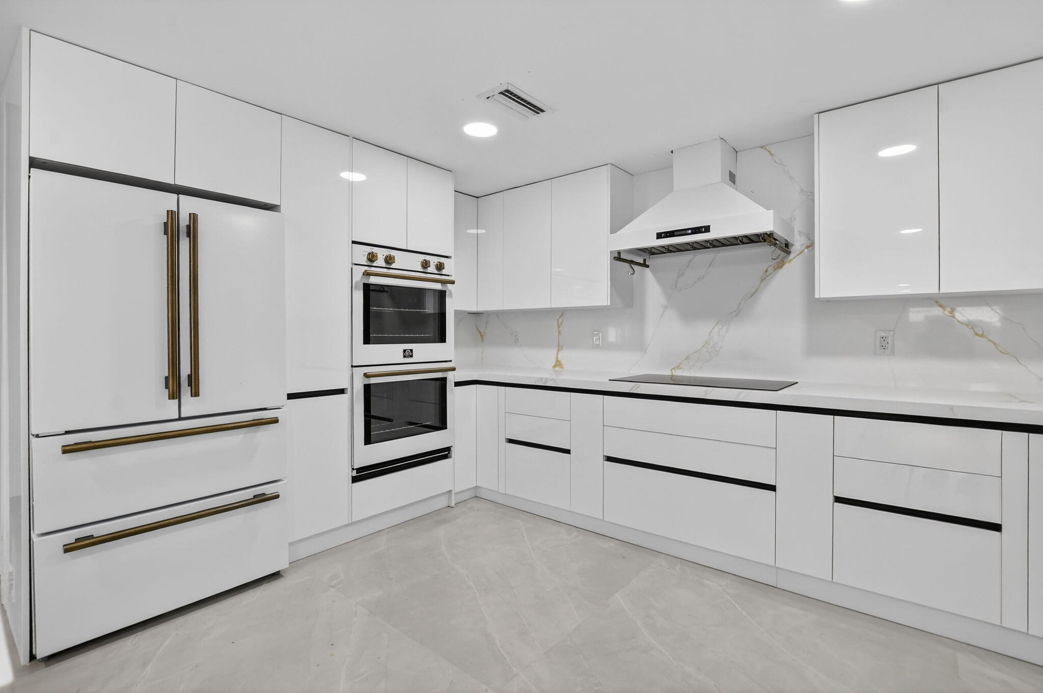 7134 San Sebastian Drive Boca Raton, FL 33433 - Photo 16 of 73 a kitchen with granite countertop white cabinets and stainless steel appliances
