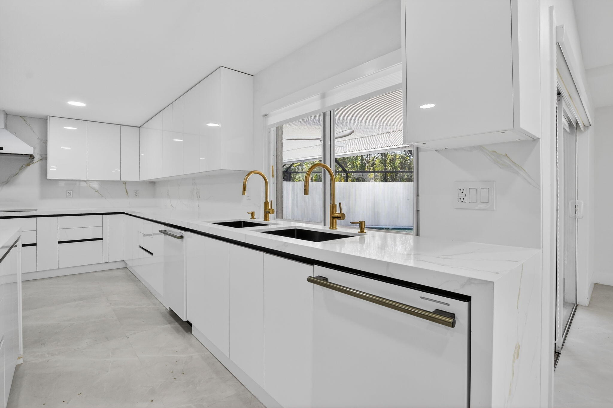 7134 San Sebastian Drive Boca Raton, FL 33433 - Photo 20 of 73 a kitchen with stainless steel appliances a sink and cabinets