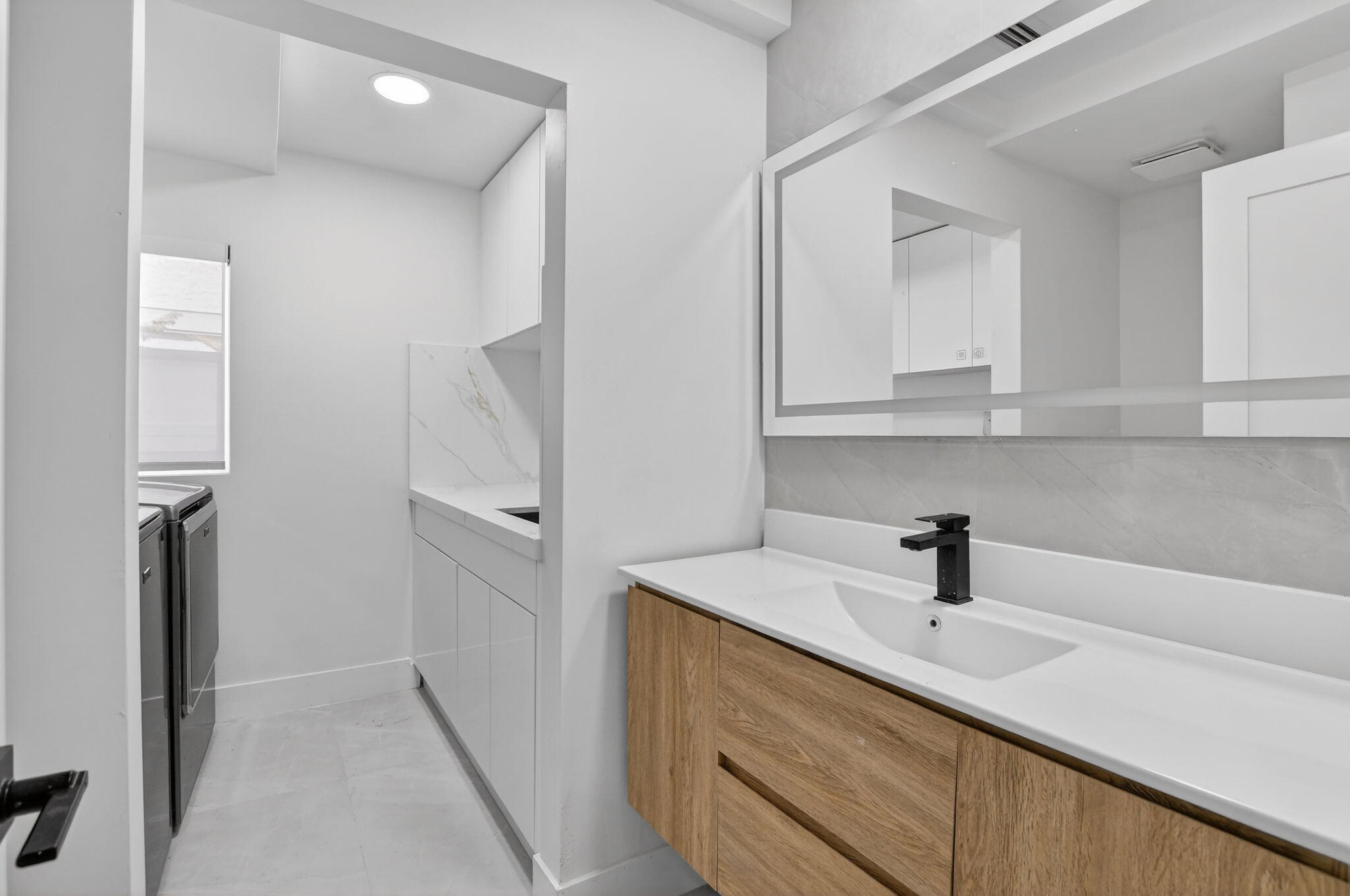 7134 San Sebastian Drive Boca Raton, FL 33433 - Photo 22 of 73 a kitchen with a sink and refrigerator