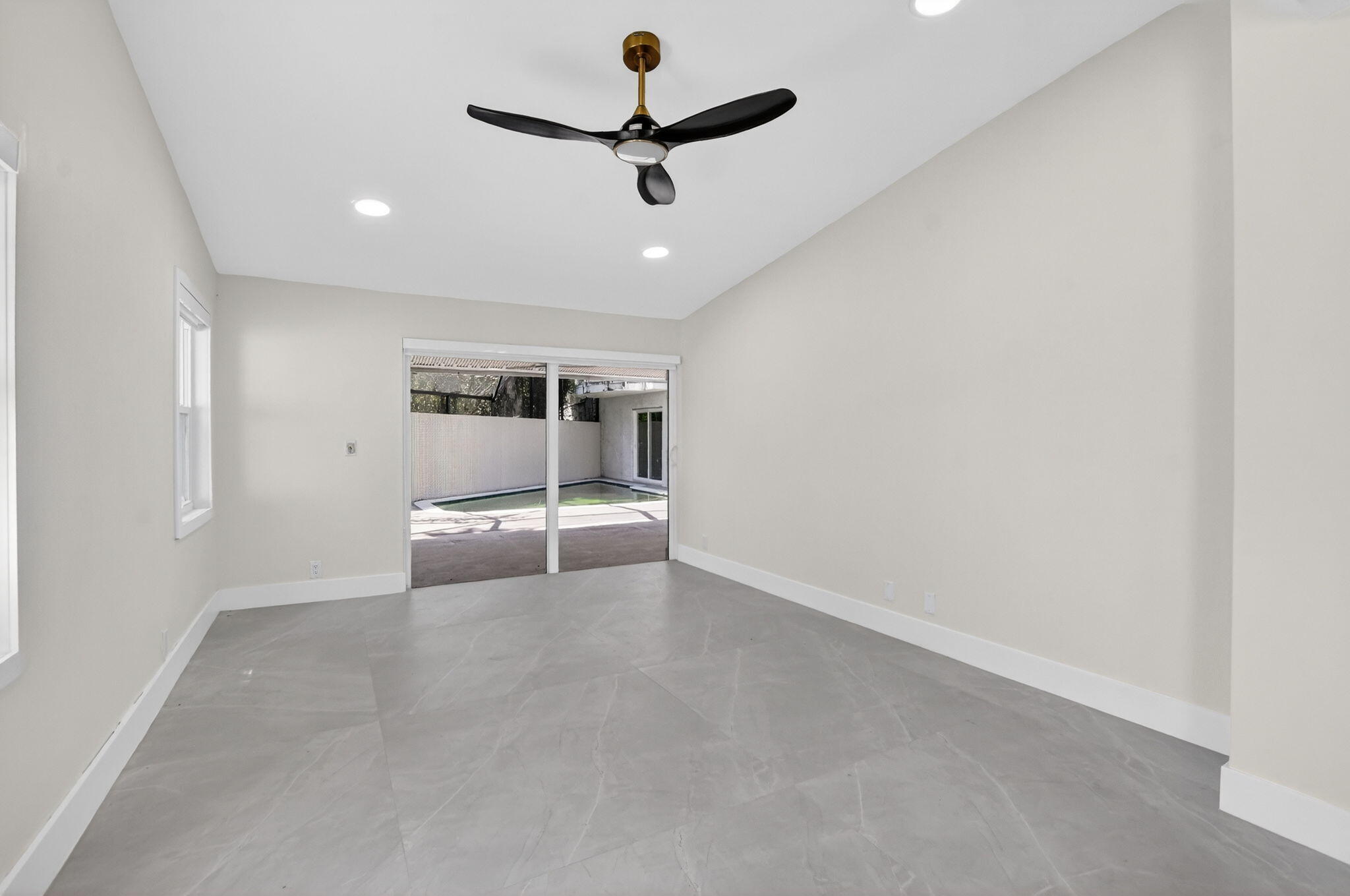 7134 San Sebastian Drive Boca Raton, FL 33433 - Photo 28 of 73 en empty room with ceiling fan and window