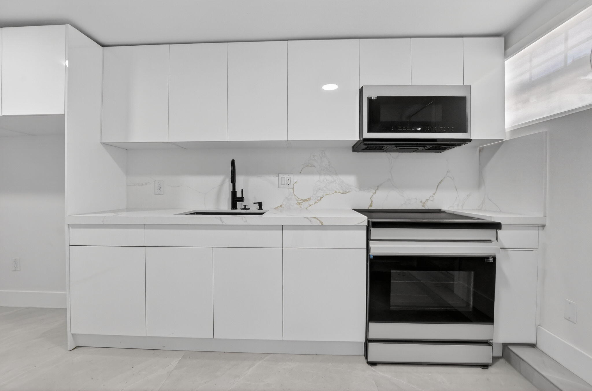 7134 San Sebastian Drive Boca Raton, FL 33433 - Photo 50 of 73 a kitchen with white cabinets and stainless steel appliances