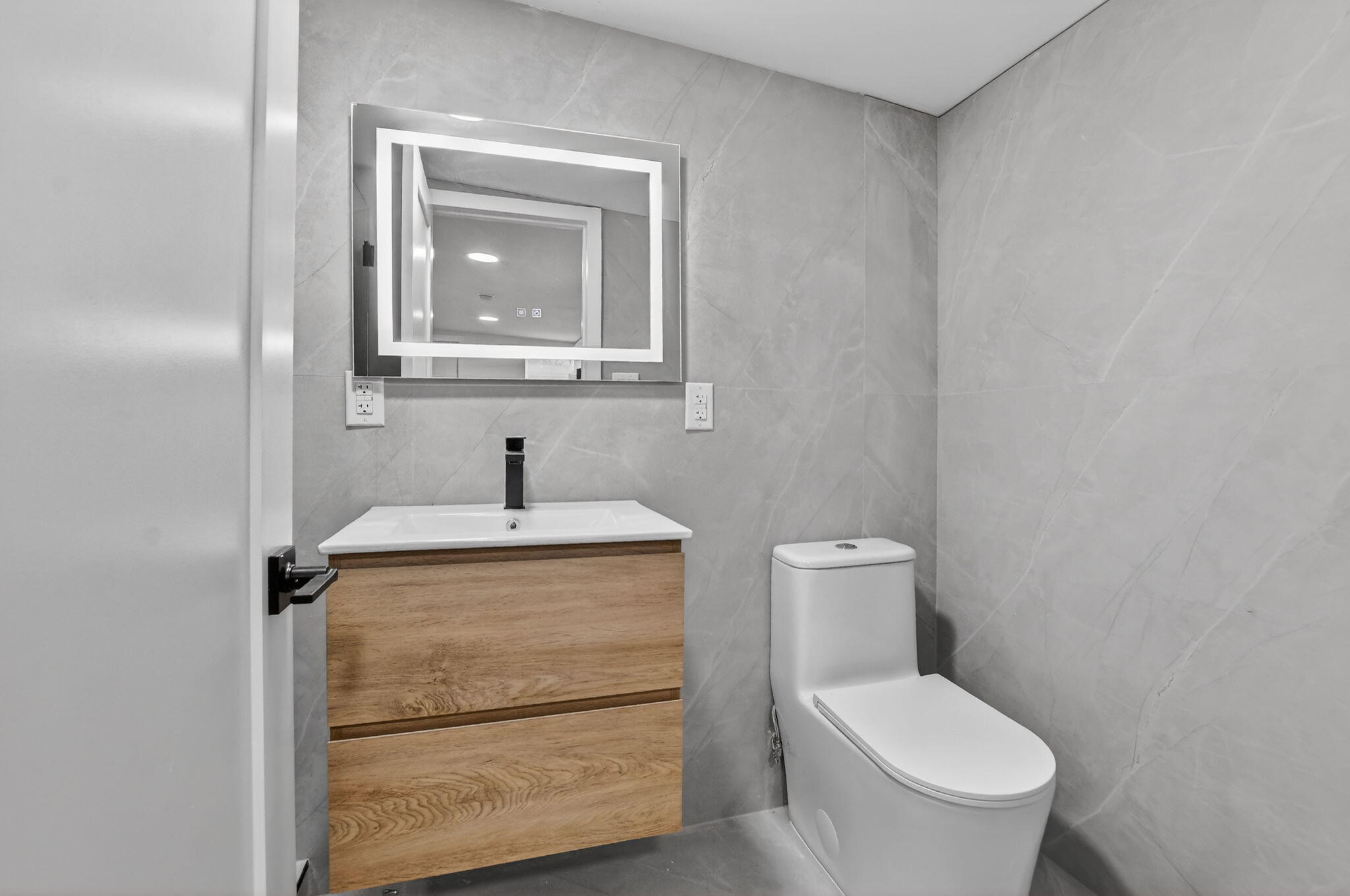 7134 San Sebastian Drive Boca Raton, FL 33433 - Photo 53 of 73 a bathroom with a toilet sink and mirror