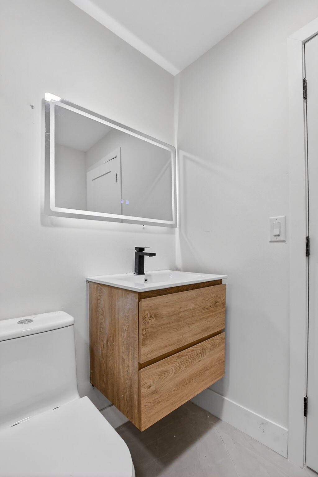 7134 San Sebastian Drive Boca Raton, FL 33433 - Photo 62 of 73 a bathroom with a sink a toilet and mirror