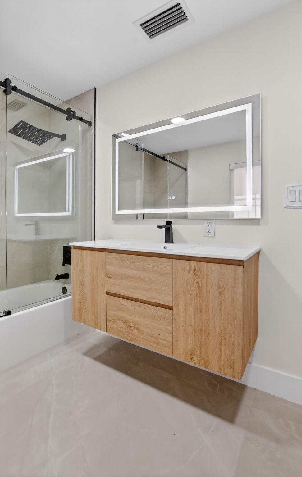 7134 San Sebastian Drive Boca Raton, FL 33433 - Photo 64 of 73 a bathroom with a tub a sink and a large mirror