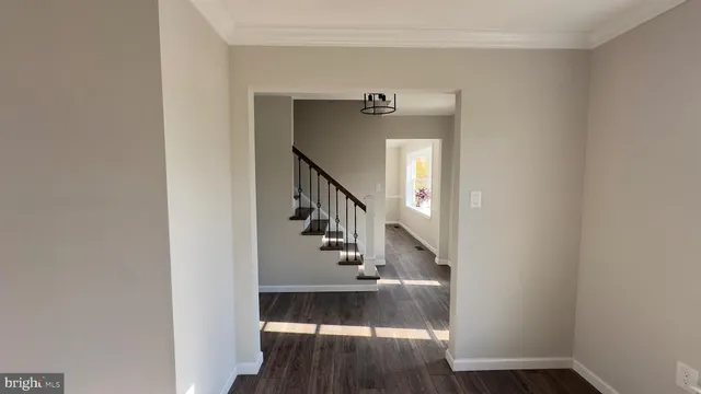 a view of entryway and hall with wooden floor