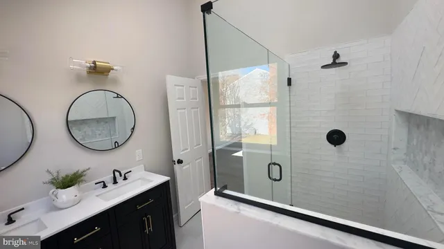 a bathroom with a granite countertop sink a mirror a vanity and shower