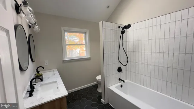 a bathroom with a bath tub with a shower
