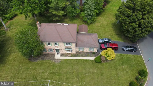 an aerial view of a house with table and chairs
