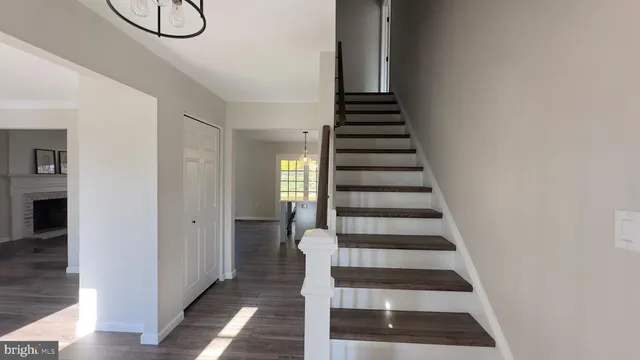 a view of entryway with wooden floor and white walls