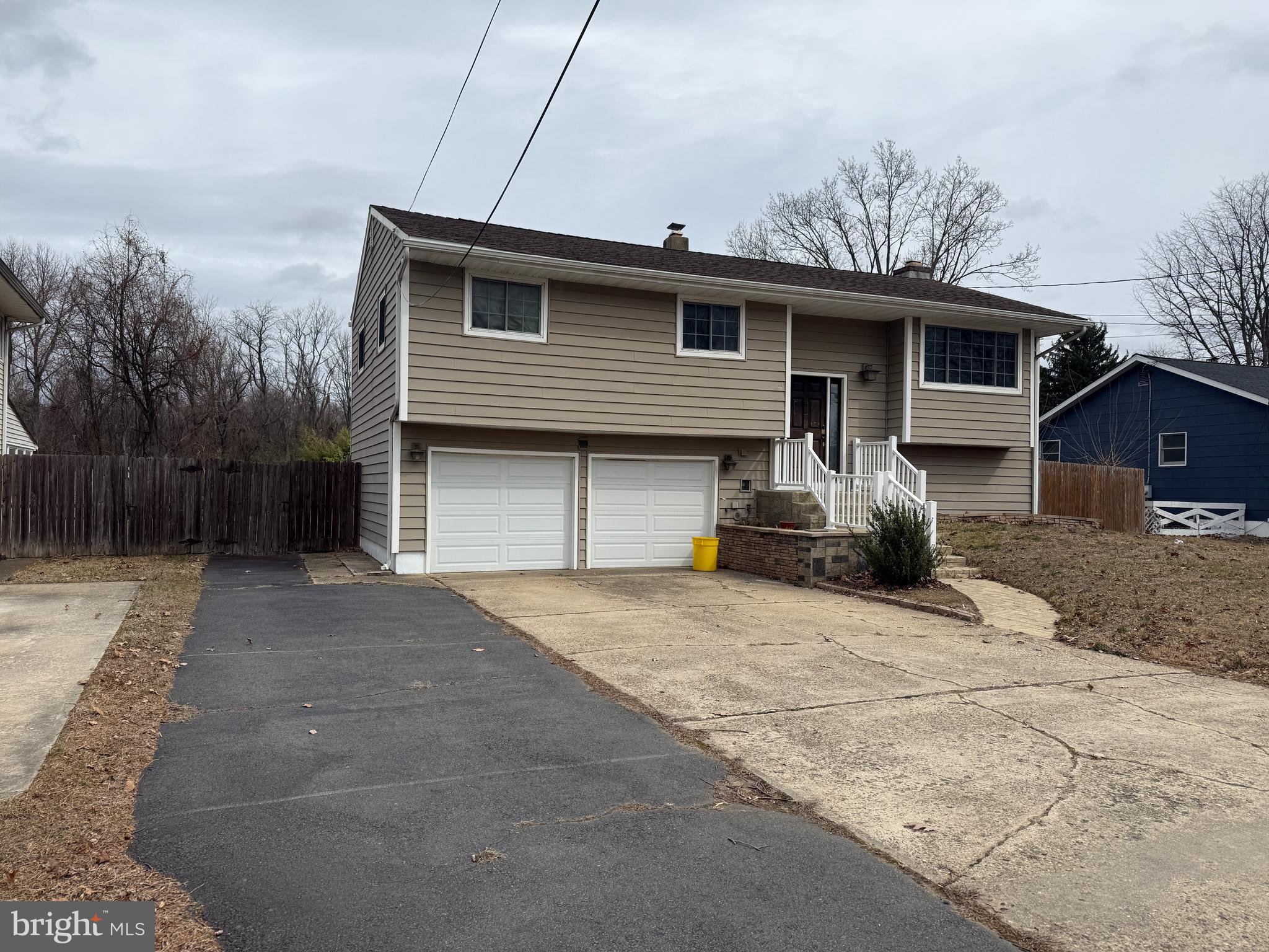 892 Estates Boulevard Hamilton, NJ 08690 - Photo 2 of 10 a front view of a house with a yard and garage