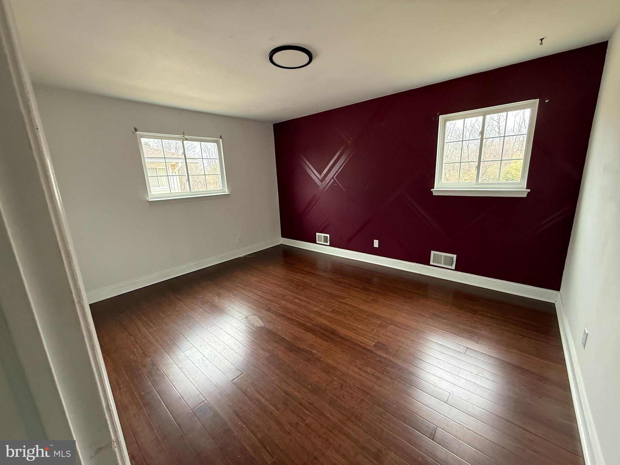 892 Estates Boulevard Hamilton, NJ 08690 - Photo 7 of 10 an empty room with wooden floor and windows