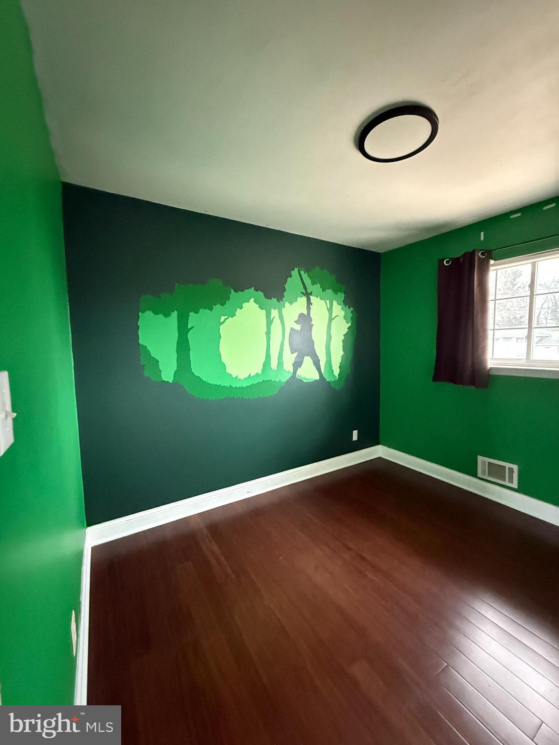 892 Estates Boulevard Hamilton, NJ 08690 - Photo 9 of 10 a view of an empty room with a window and wooden floor