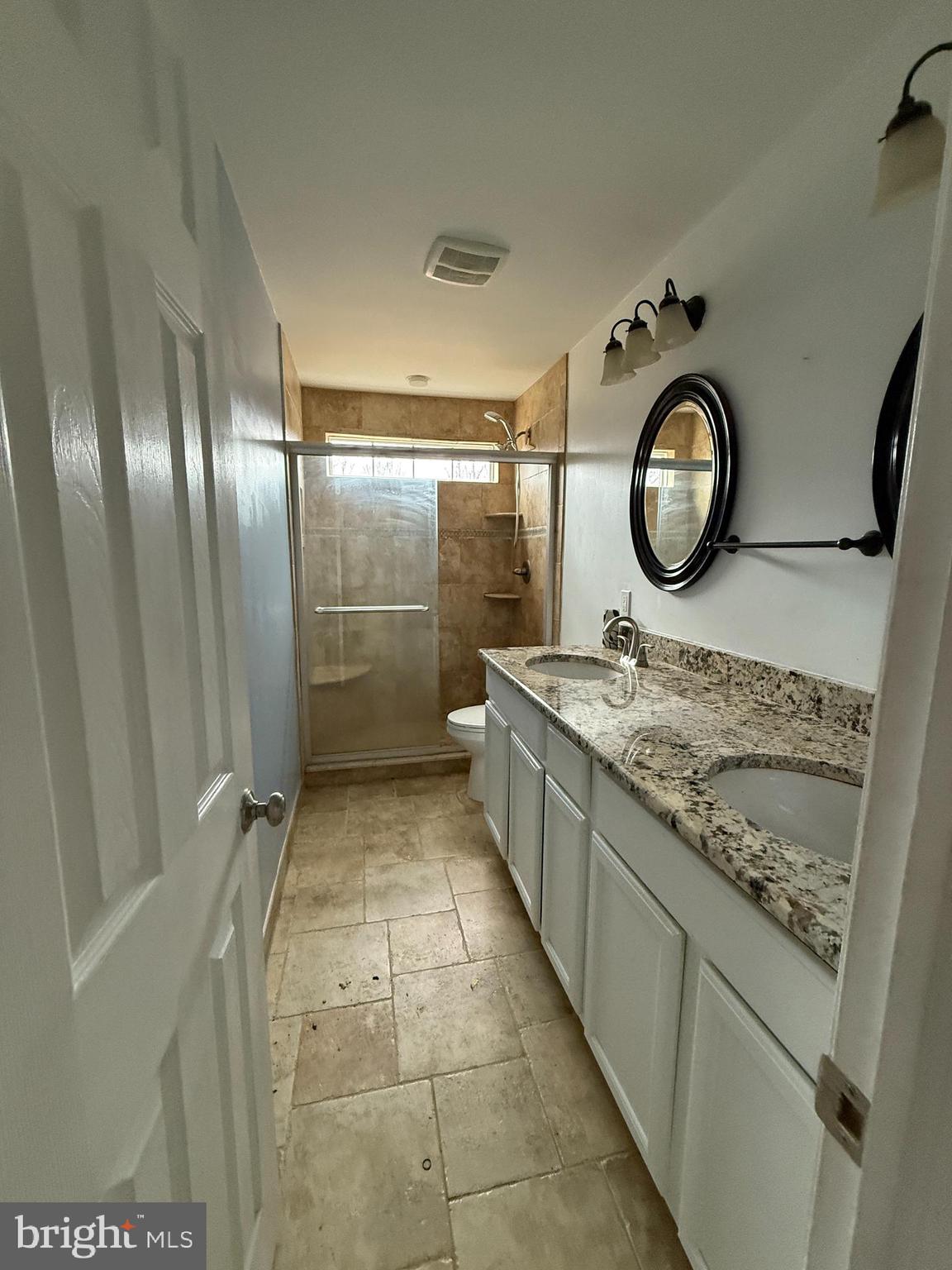 892 Estates Boulevard Hamilton, NJ 08690 - Photo 10 of 10 a bathroom with a granite countertop sink and a mirror