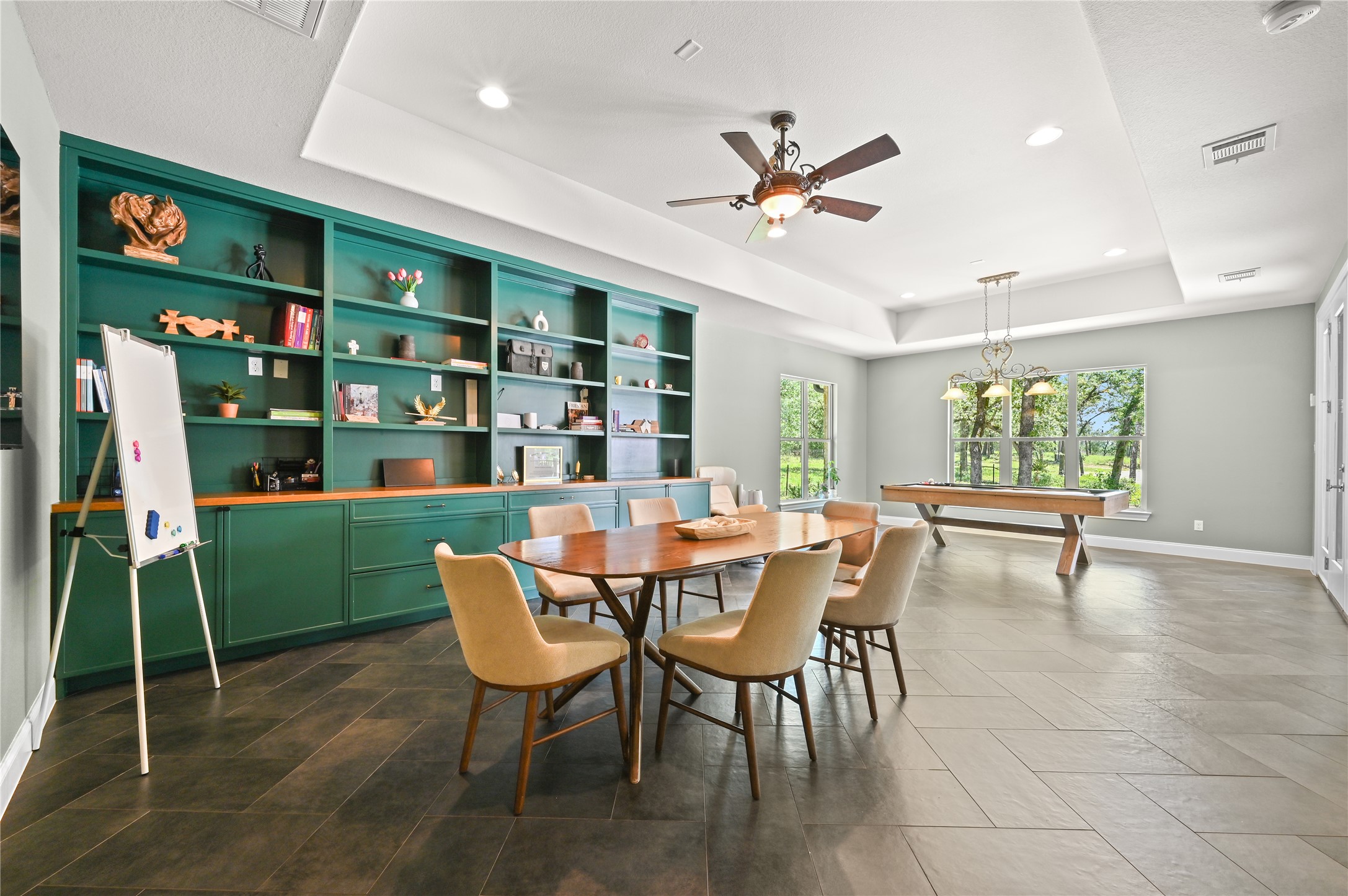 387 Corral Road Smithville, TX 78957 - Photo 23 of 40 Spacious room featuring extensive built-in shelving with cabinetry, tray ceiling, and large windows