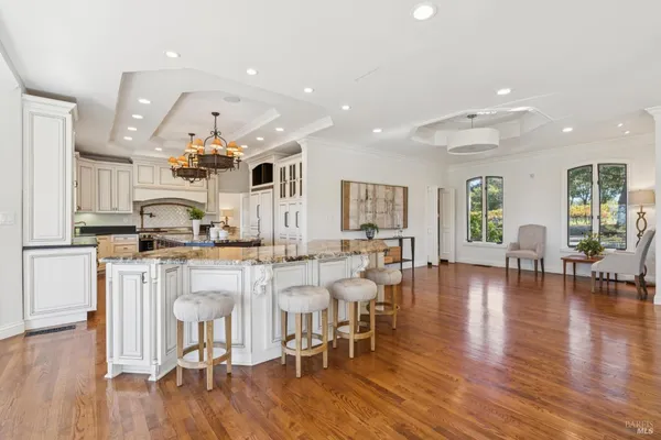 a large kitchen with a table and chairs