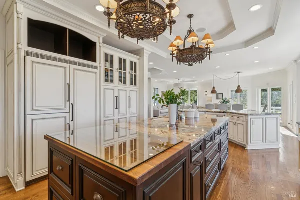 a view of a dining room with furniture wooden floor and chandelier