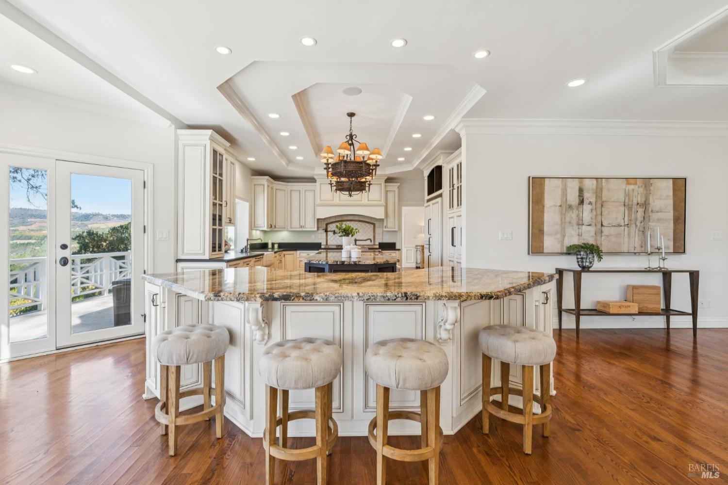 3265 Soda Canyon Road Napa, CA 94558 - Photo 16 of 36 a kitchen with stainless steel appliances kitchen island granite countertop a table and chairs in it