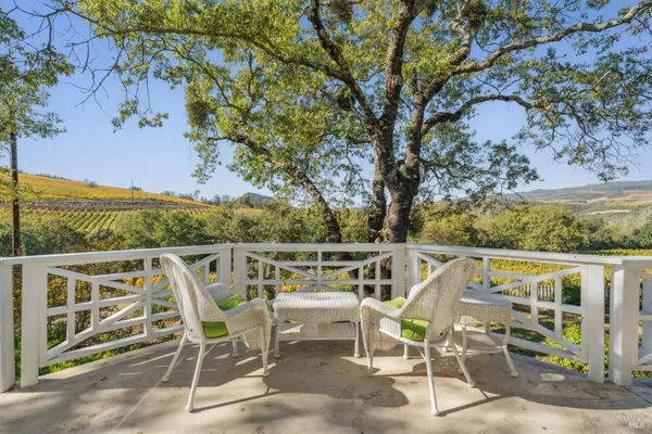 a view of a balcony with chairs