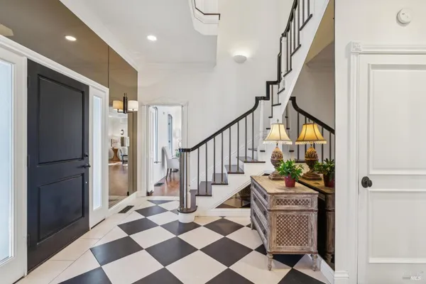 a view of entryway with wooden floor and stairs