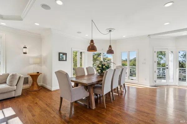 a view of a dining room with furniture window and wooden floor
