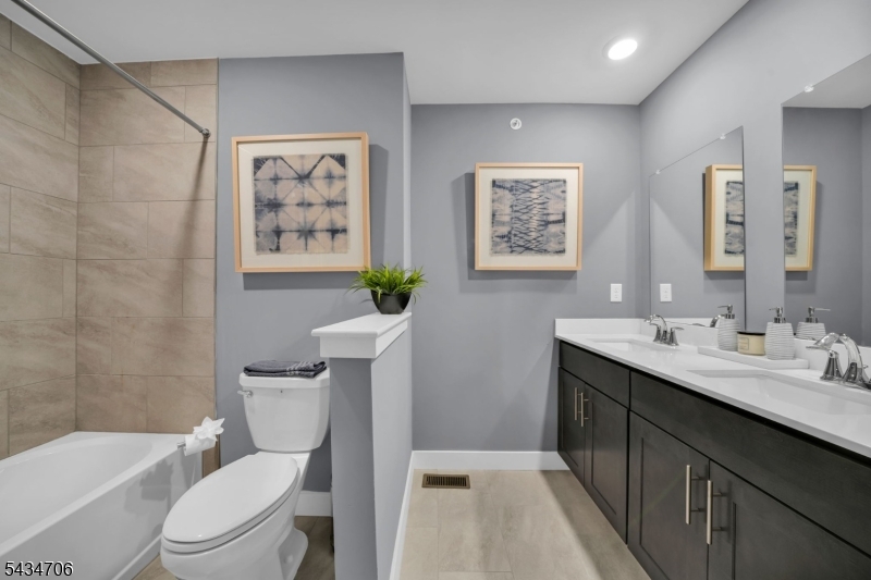 2 Doherty Way Morris Plains, NJ 07950 - Photo 18 of 33 a bathroom with a toilet a sink a bath tub and mirror