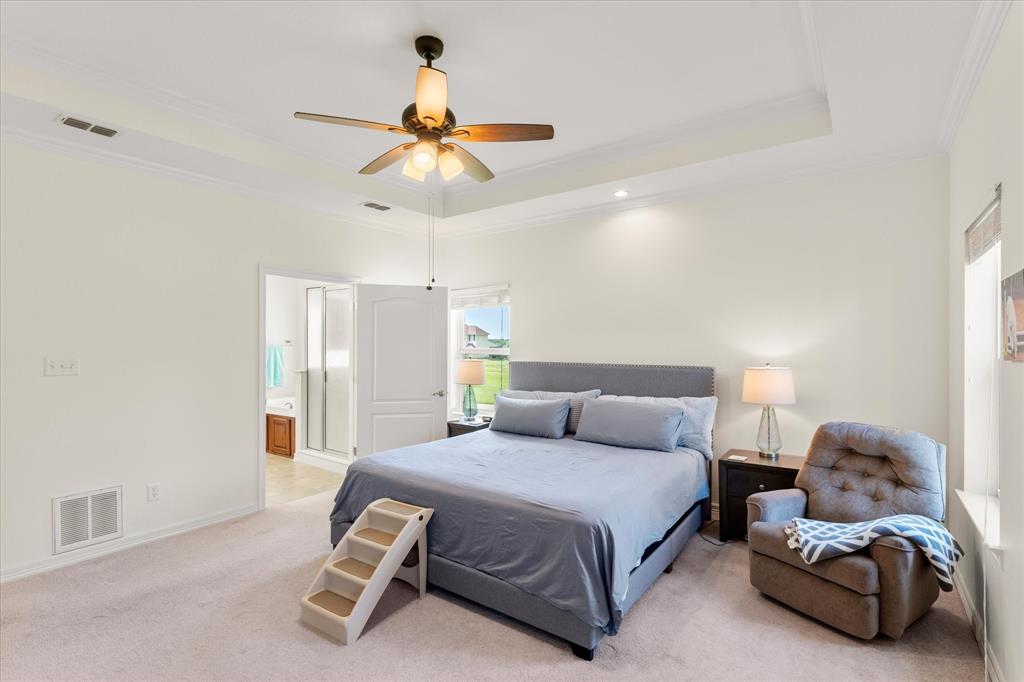 345 Rains County Road 3390 Emory, TX 75440 - Photo 25 of 39 a bedroom with a bed and a chandelier