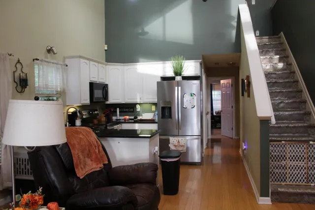 a kitchen with stainless steel appliances a refrigerator sink and microwave