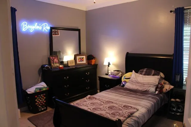 a bedroom with a bed and a lamp