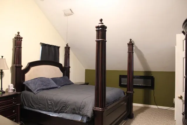 a bedroom with a bed and dresser