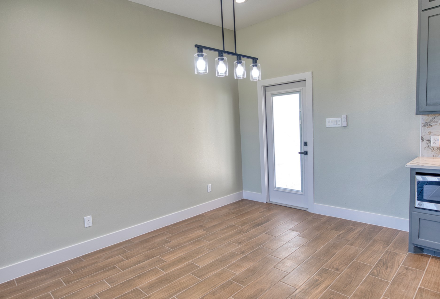 925 Buffalo Trail Angleton, TX 77515 - Photo 17 of 45 a view of an empty room with wooden floor and a window