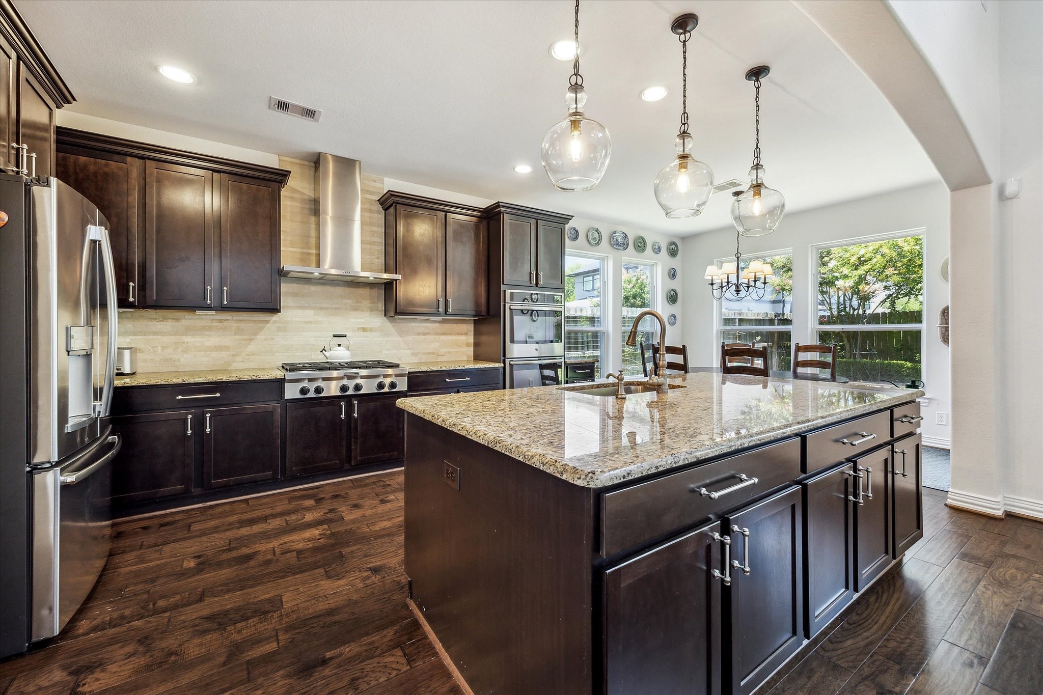 1515 Thornton Road Houston, TX 77018 - Photo 13 of 38 Adjacent to the living room, the home features an open-concept gourmet kitchen outfitted with high-end appliances, a large central island and a breakfast area with convenient access to the backyard and patio.