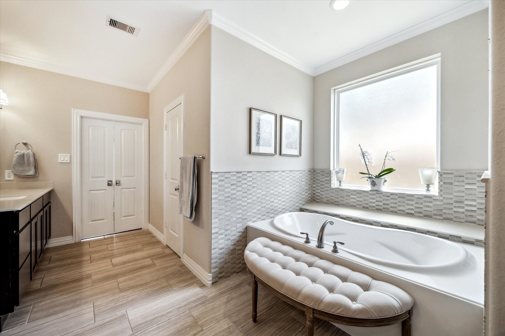 1515 Thornton Road Houston, TX 77018 - Photo 21 of 38 The luxurious primary bathroom features dual full-sized vanities, an expansive walk-in shower, and an oversized bathtub beneath a semi-transparent window for ample natural light and privacy.
