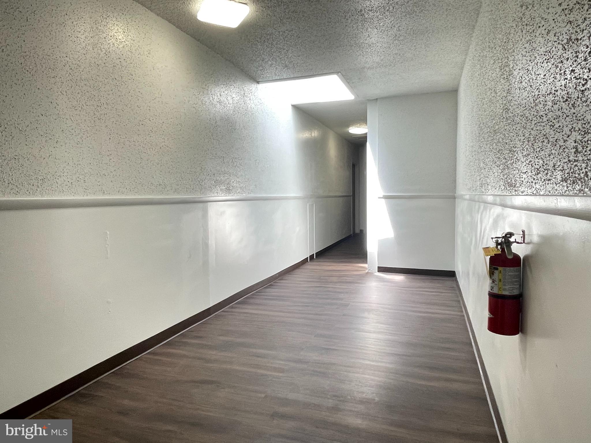 317 Bridge Street, Unit 2 Phoenixville, PA 19460 - Photo 4 of 12 a view of a hallway with wooden floor