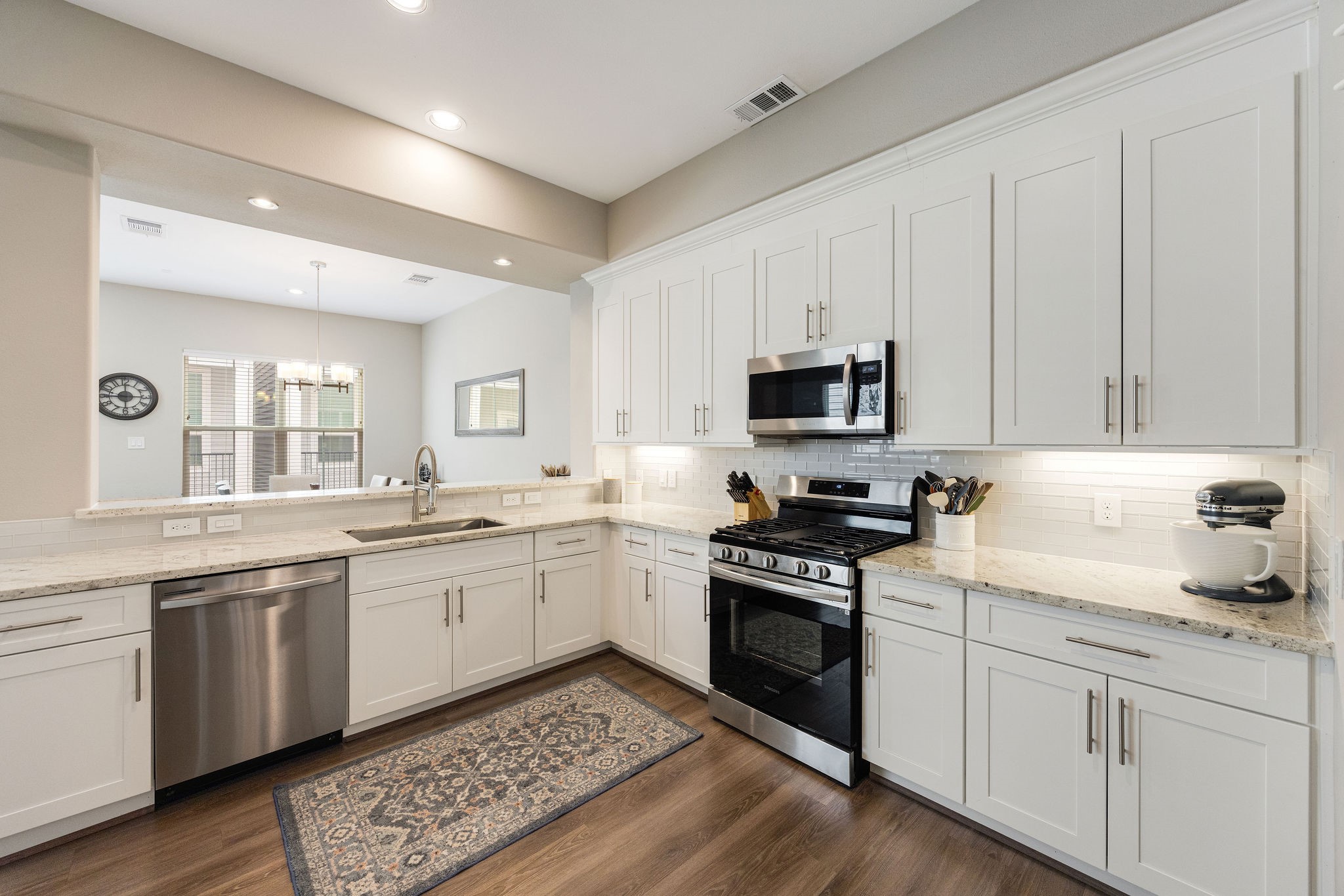 603 Link Road, Unit F Houston, TX 77009 - Photo 6 of 16 Thoughtfully designed kitchen featuring stainless steel and black appliances, farmhouse sink, and generous counter space.