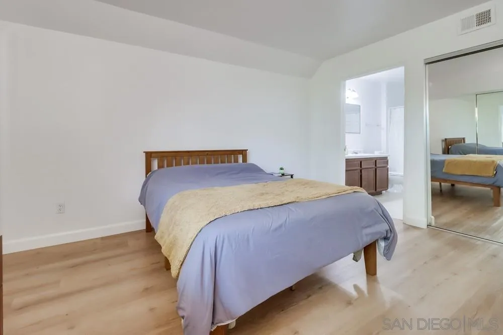 6191 Rancho Mission Road, Unit 105 San Diego, CA 92108 - Photo 12 of 31 a bedroom with a bed and a table