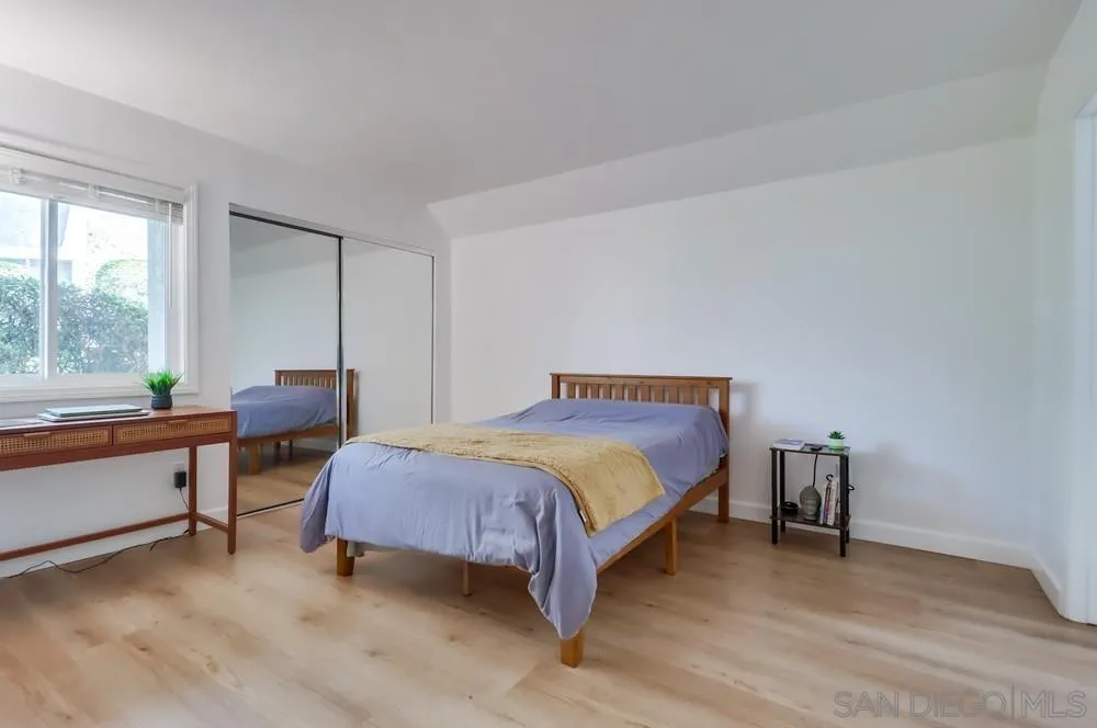 6191 Rancho Mission Road, Unit 105 San Diego, CA 92108 - Photo 14 of 31 a bedroom with a bed and a large window