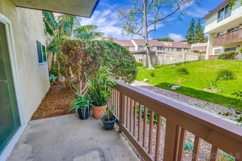 6191 Rancho Mission Road, Unit 105 San Diego, CA 92108 - Photo 19 of 31 a view of a porch with a table and chairs