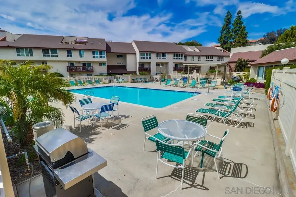 6191 Rancho Mission Road, Unit 105 San Diego, CA 92108 - Photo 26 of 31 a view of a patio with swimming pool table and chairs