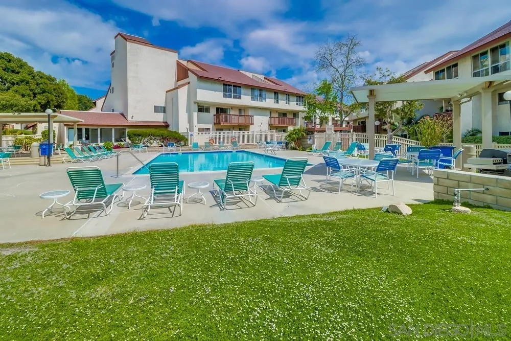 6191 Rancho Mission Road, Unit 105 San Diego, CA 92108 - Photo 27 of 31 a view of a patio with table and chairs potted plants and large tree