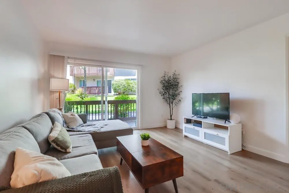 6191 Rancho Mission Road, Unit 105 San Diego, CA 92108 - Photo 3 of 31 a living room with furniture and a flat screen tv