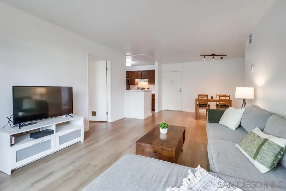 6191 Rancho Mission Road, Unit 105 San Diego, CA 92108 - Photo 5 of 31 a living room with furniture and a flat screen tv