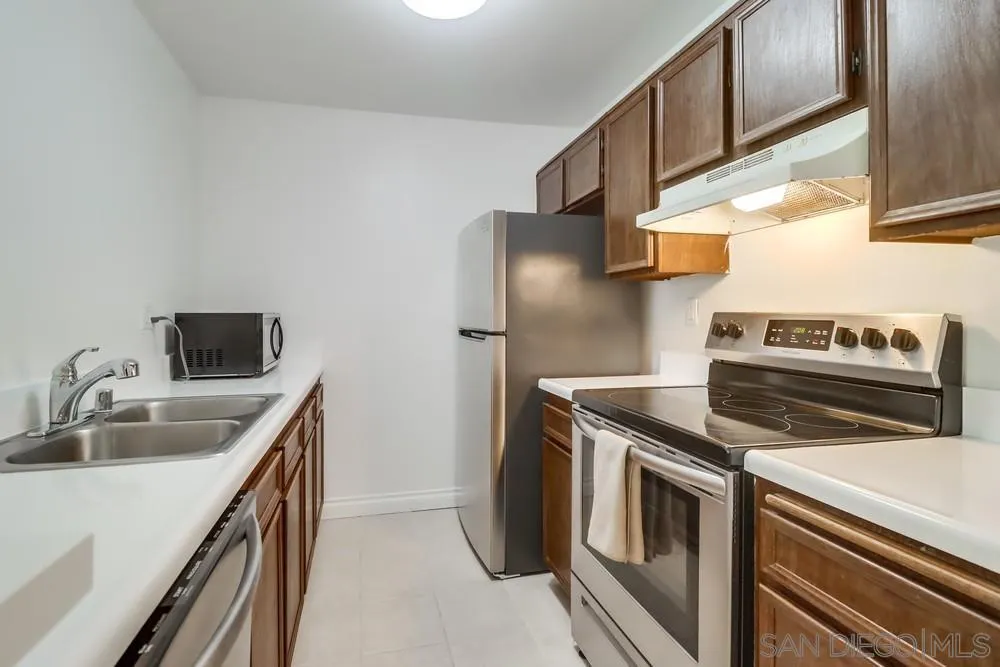 6191 Rancho Mission Road, Unit 105 San Diego, CA 92108 - Photo 9 of 31 a kitchen with a sink and a refrigerator