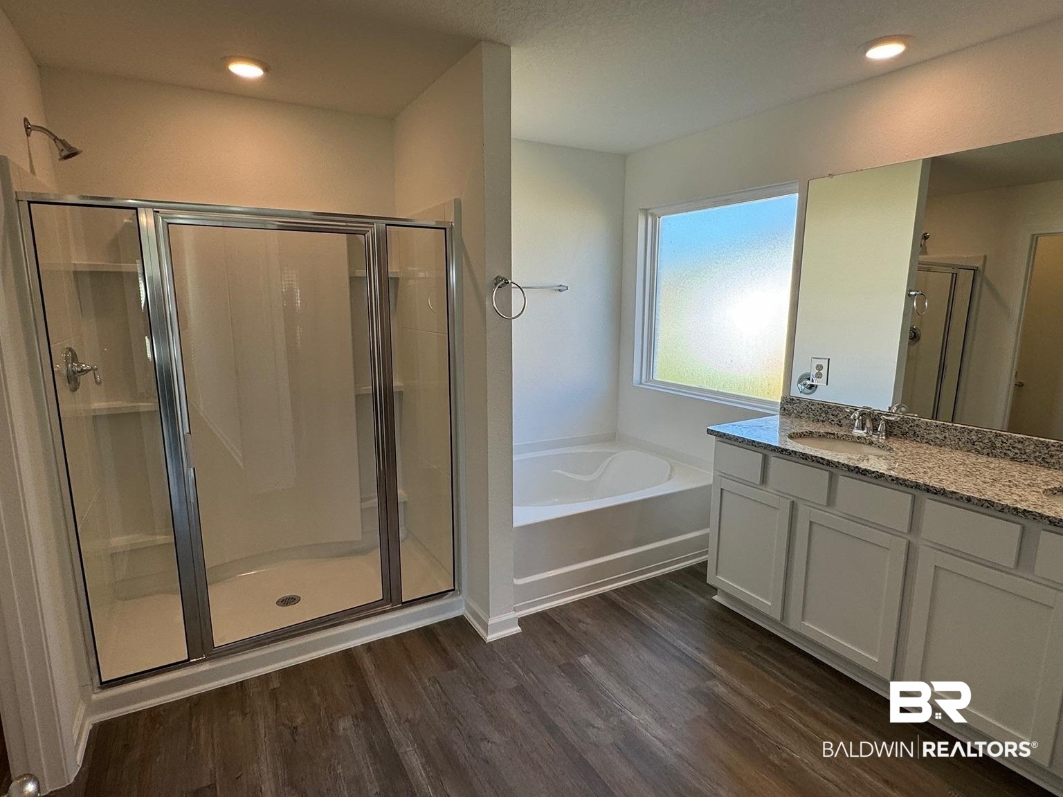 24321 Ringneck Loop Elberta, AL 36530 - Photo 12 of 39 Bathroom featuring hardwood / wood-style floors, vanity, and shower with separate bathtub