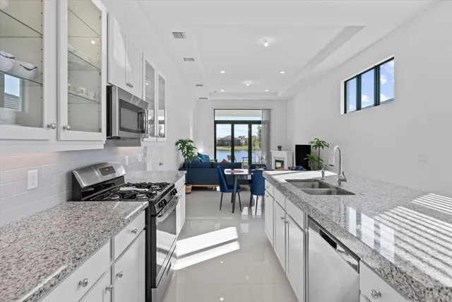 a kitchen with granite countertop lots of counter top space and stainless steel appliances