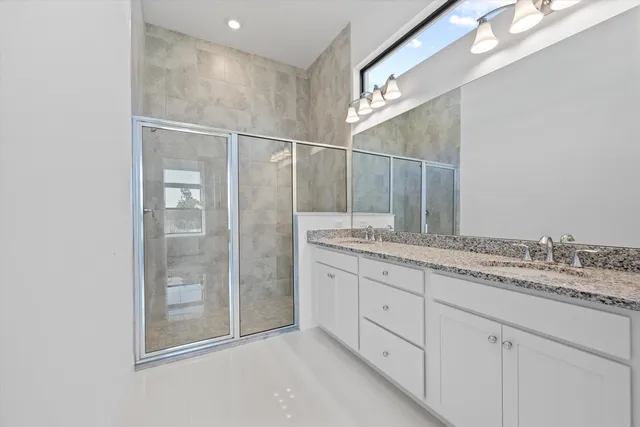 a bedroom with two beds and a window