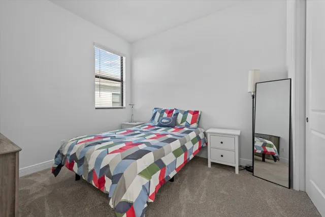 a bathroom with a granite countertop bathtub shower sink vanity and toilet