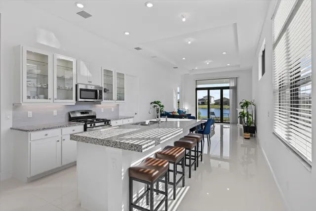 a large kitchen with lots of counter space a sink and appliances
