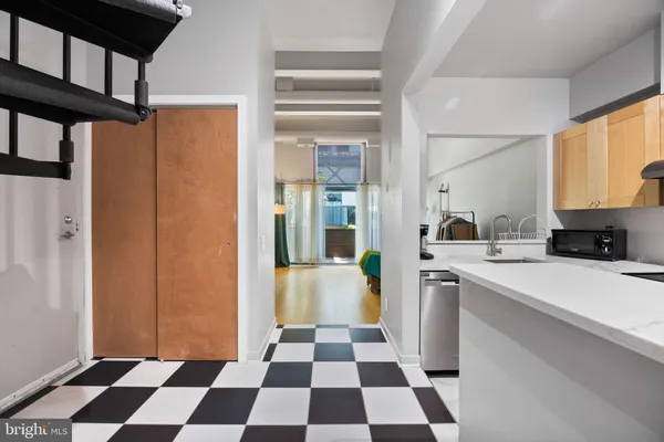 a kitchen with a refrigerator a sink and a cabinets