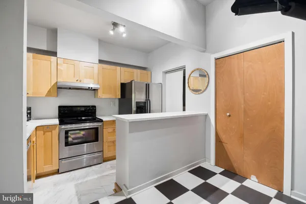 a kitchen with granite countertop stainless steel appliances a stove a sink and a microwave